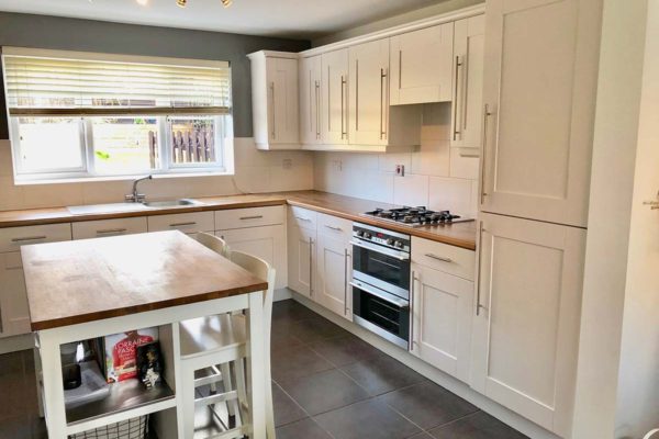after image of kitchen and island in a clean white