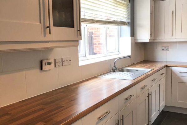 kitchen worktop surface with complimenting white cupboards