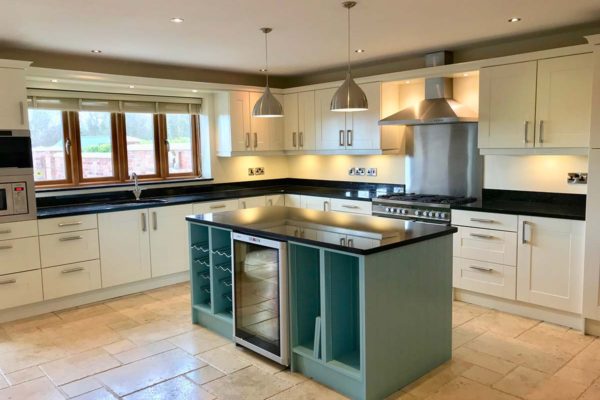 white kitchen with a green island
