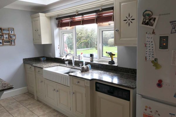 white kitchen sink and cupboards