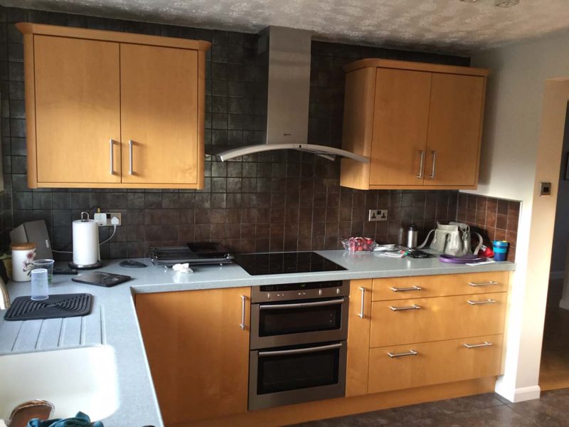before image of kitchen cupboards, drawers and oven